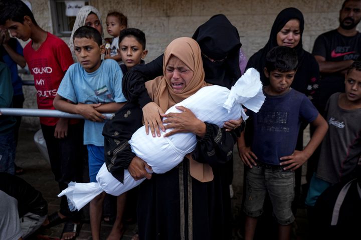 Palestinians mourn relatives killed in the Israeli bombardment of the Gaza Strip, at a hospital in Deir al-Balah, on Oct. 1, 2024.