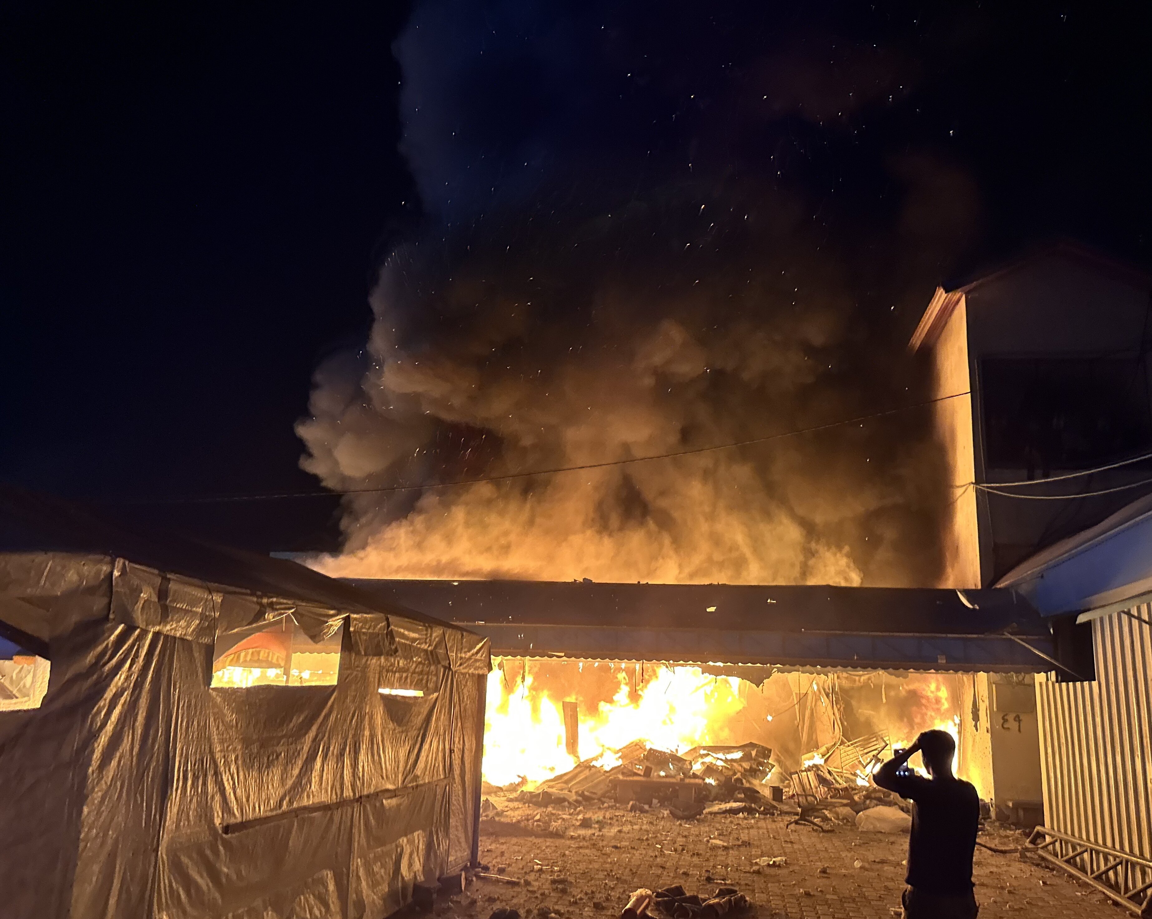 An Israeli strike sets ablaze a tent camp in the courtyard of Al-Aqsa Martyrs Hospital, in Gaza's Deir al-Balah, on Oct. 14, 2024. The fire burned many Palestinians alive, including patients.