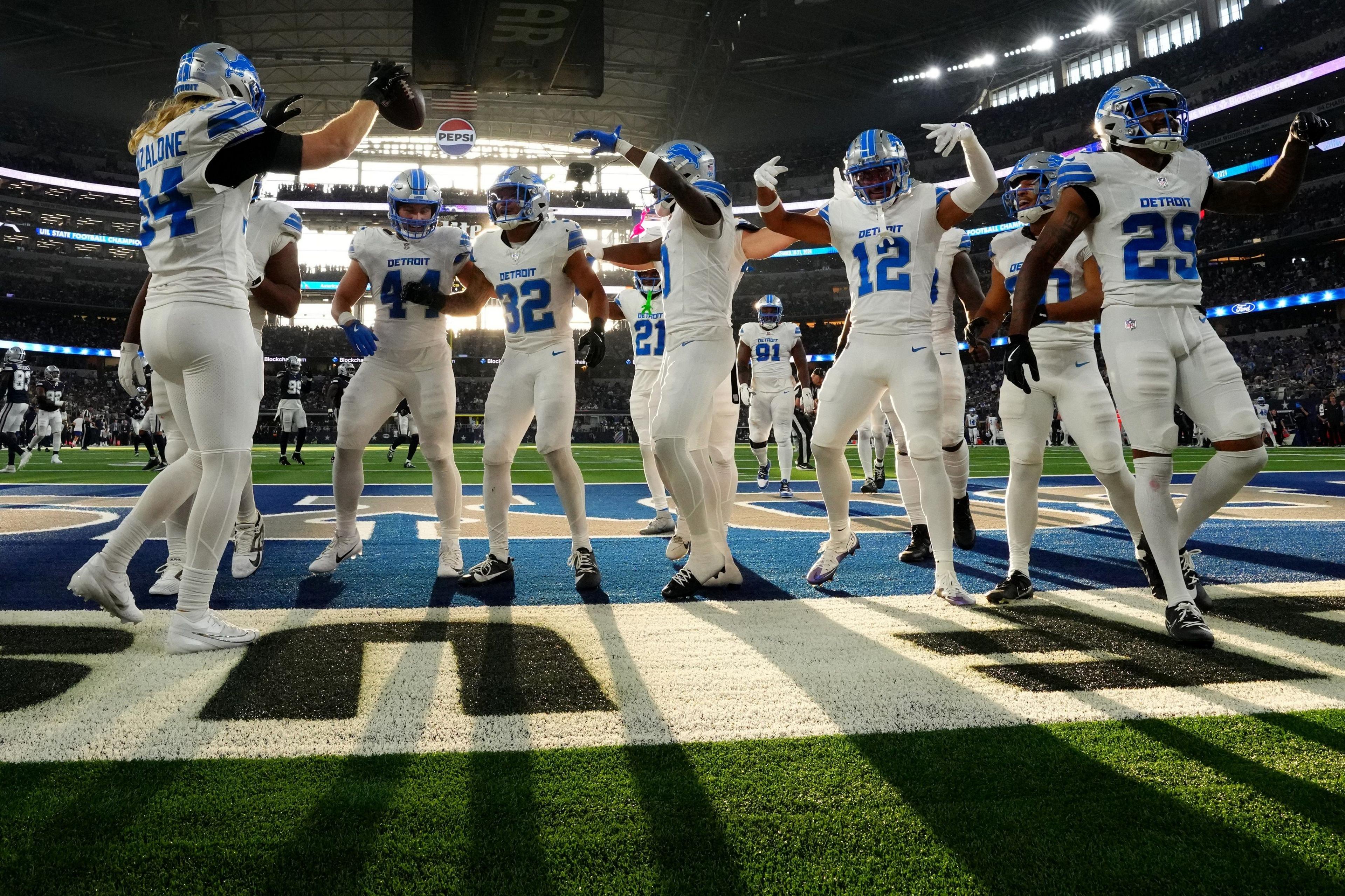 The Detroit Lions celebrate in the end zone at the Dallas Cowboys