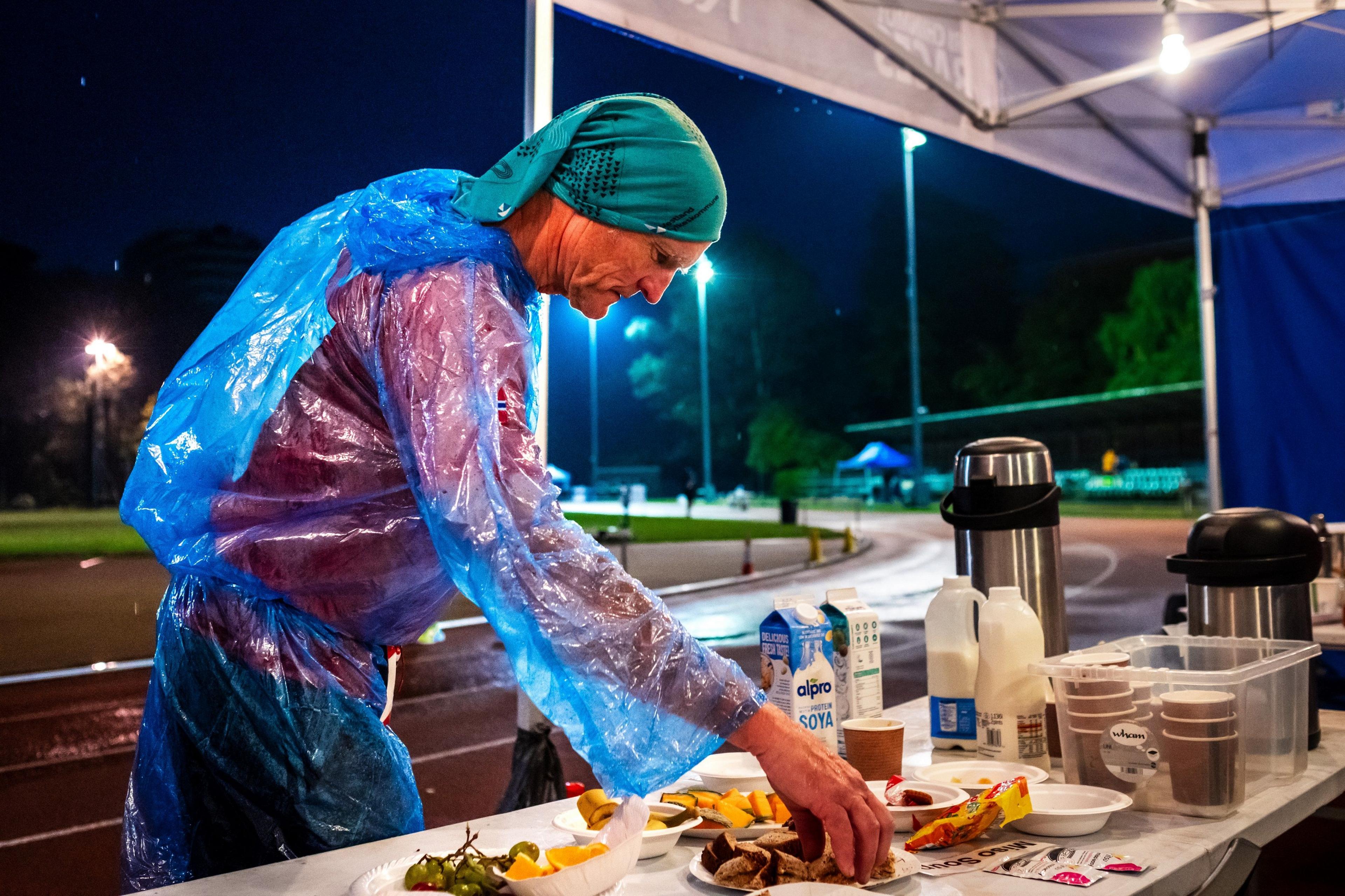 Per Audun Heskestad eats at an aid station during the Sri Chinmoy 24hr Track Race in Battersea