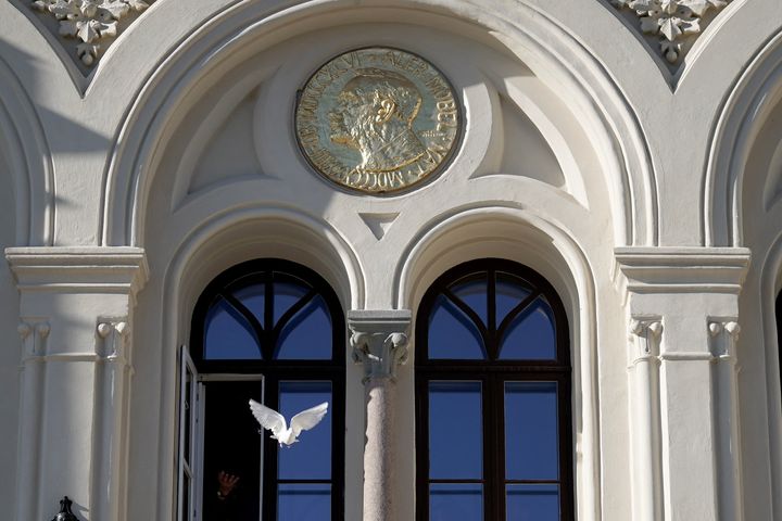 A dove flies from the window of the Nobel Peace Center in Oslo, Norway after Japanese organization Nihon Hidankyo was awarded the 2024 Nobel Peace Prize.