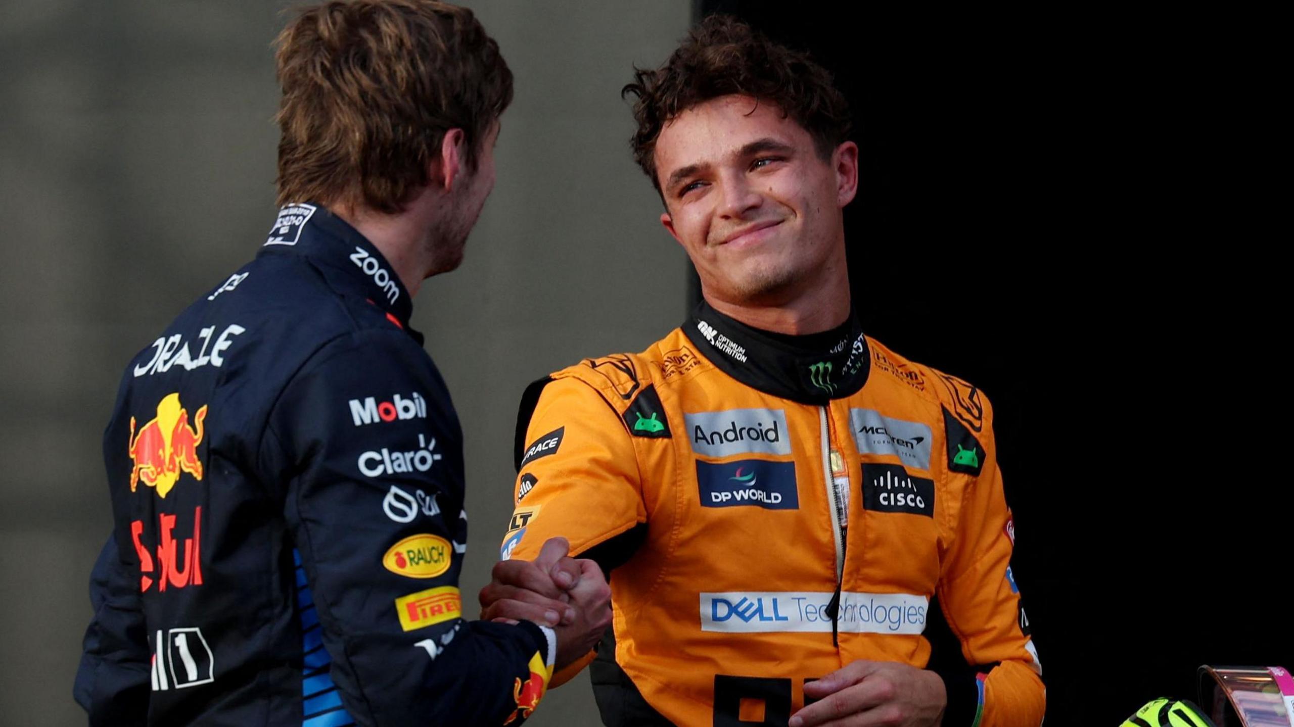 Lando Norris and Max Verstappen clasp hands after qualifying for the United States Grand Prix