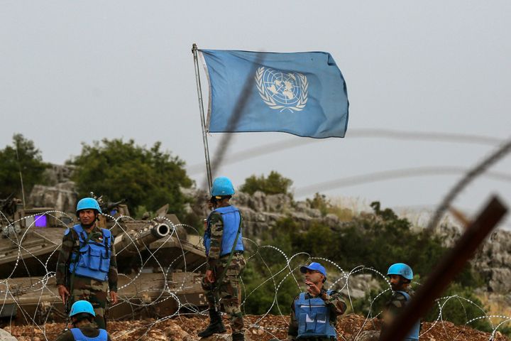 Peacekeeping soldiers with the United Nations stand in front of an Israeli tank on June 9, 2023, amid the cross-border clashes with Lebanese citizens in Kfarchouba and Shebaa Farm.