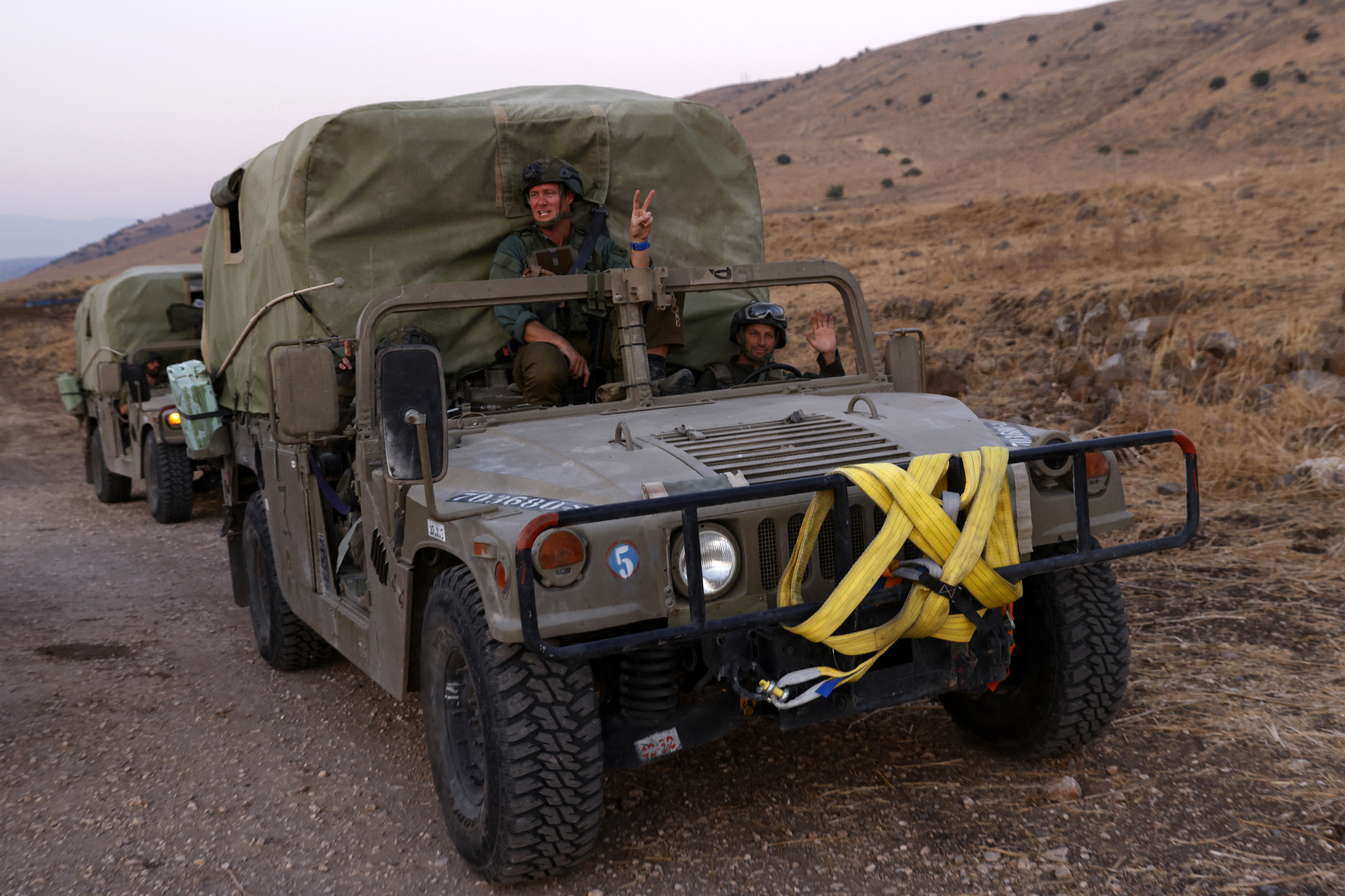 Israeli soldiers ride in a Humvee convoy in northern Israel, near the border with Lebanon on Oct. 10, 2024.