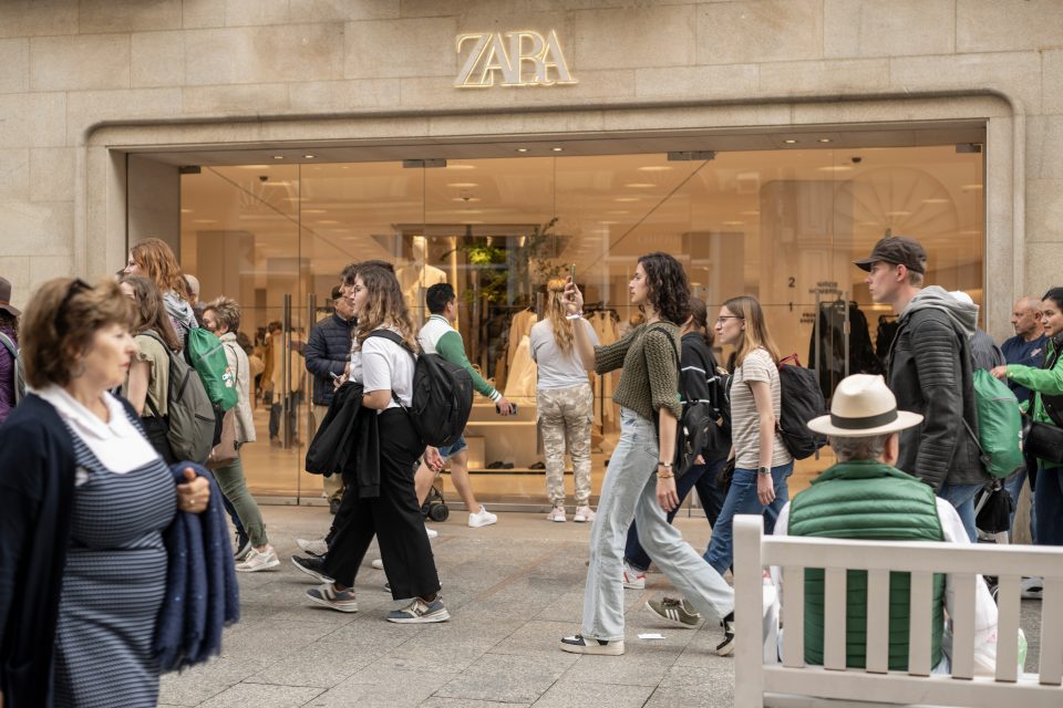 People walking outside a Zara store