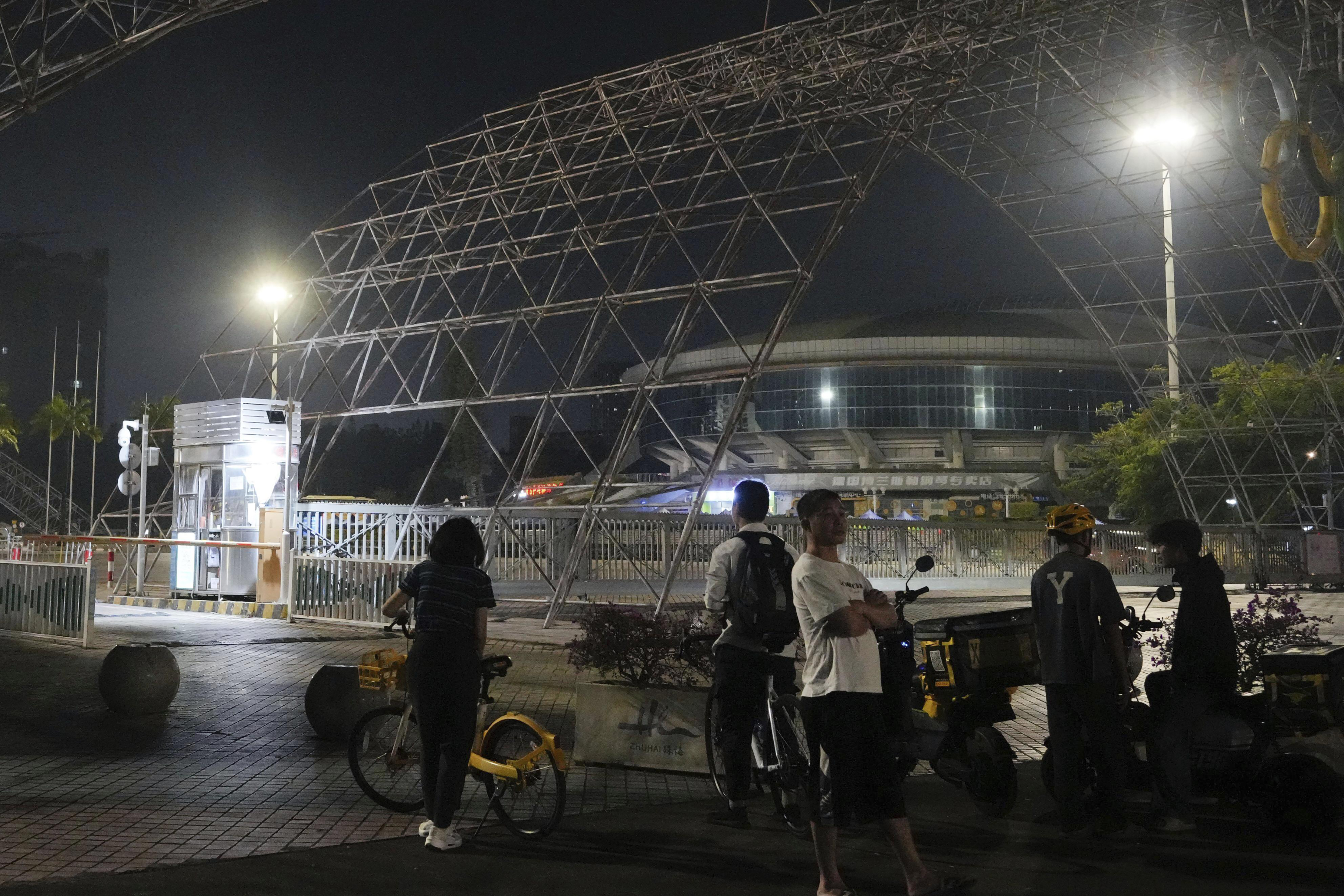 People gather near a sports center after a man rammed a car into people exercising at the center in Zhuhai, China, on Nov. 11, 2024. 