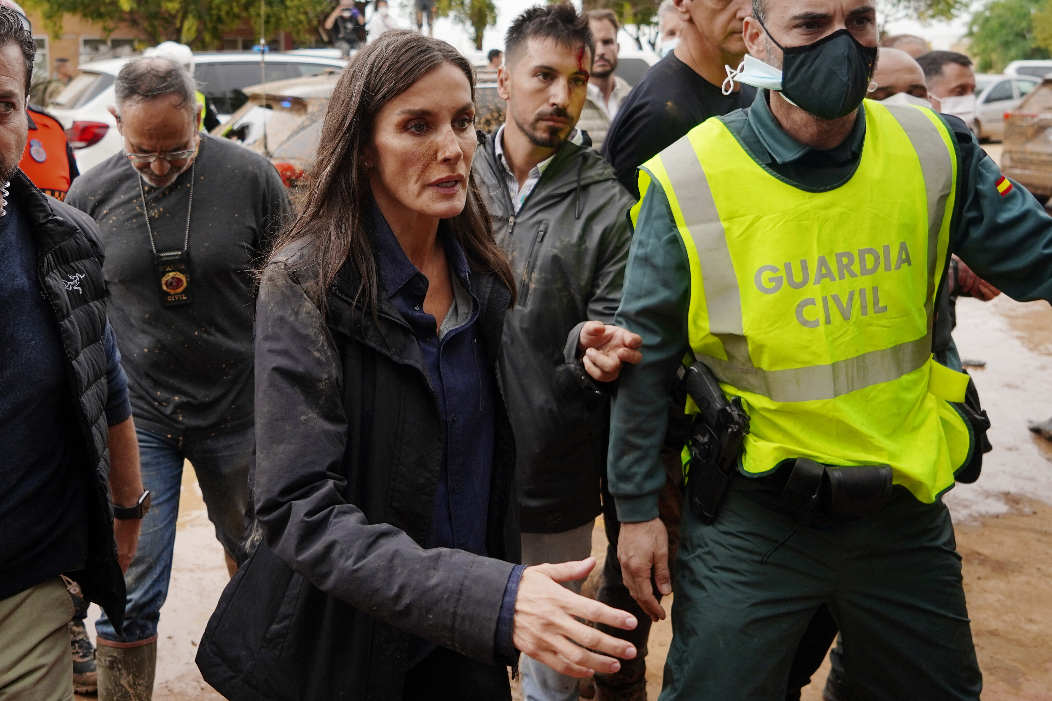 Queen Letizia of Spain, with mud stains on her face, approaches to speak with a town resident during the Spanish royal couple's visit to Paiporta, in the region of Valencia, eastern Spain, on November 3.