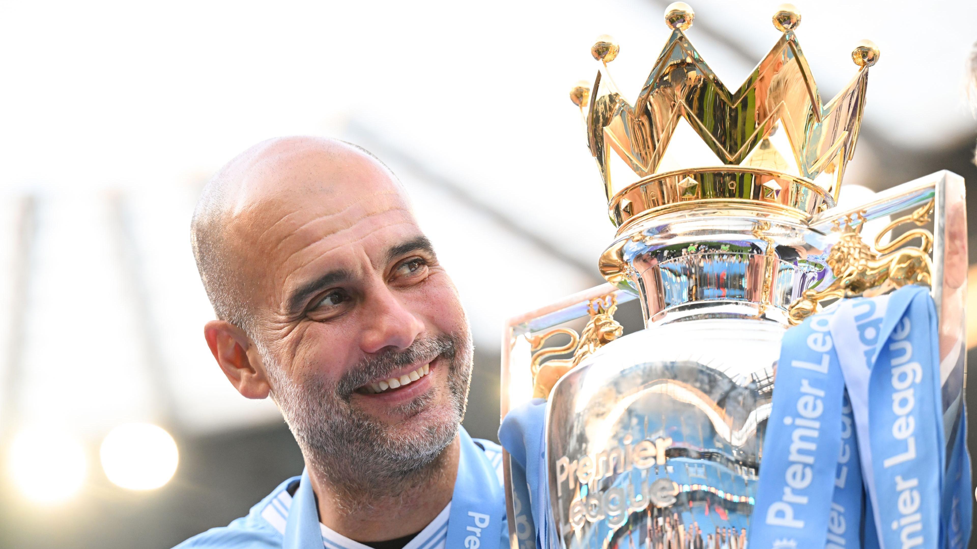 Pep Guardiola with the Premier League trophy