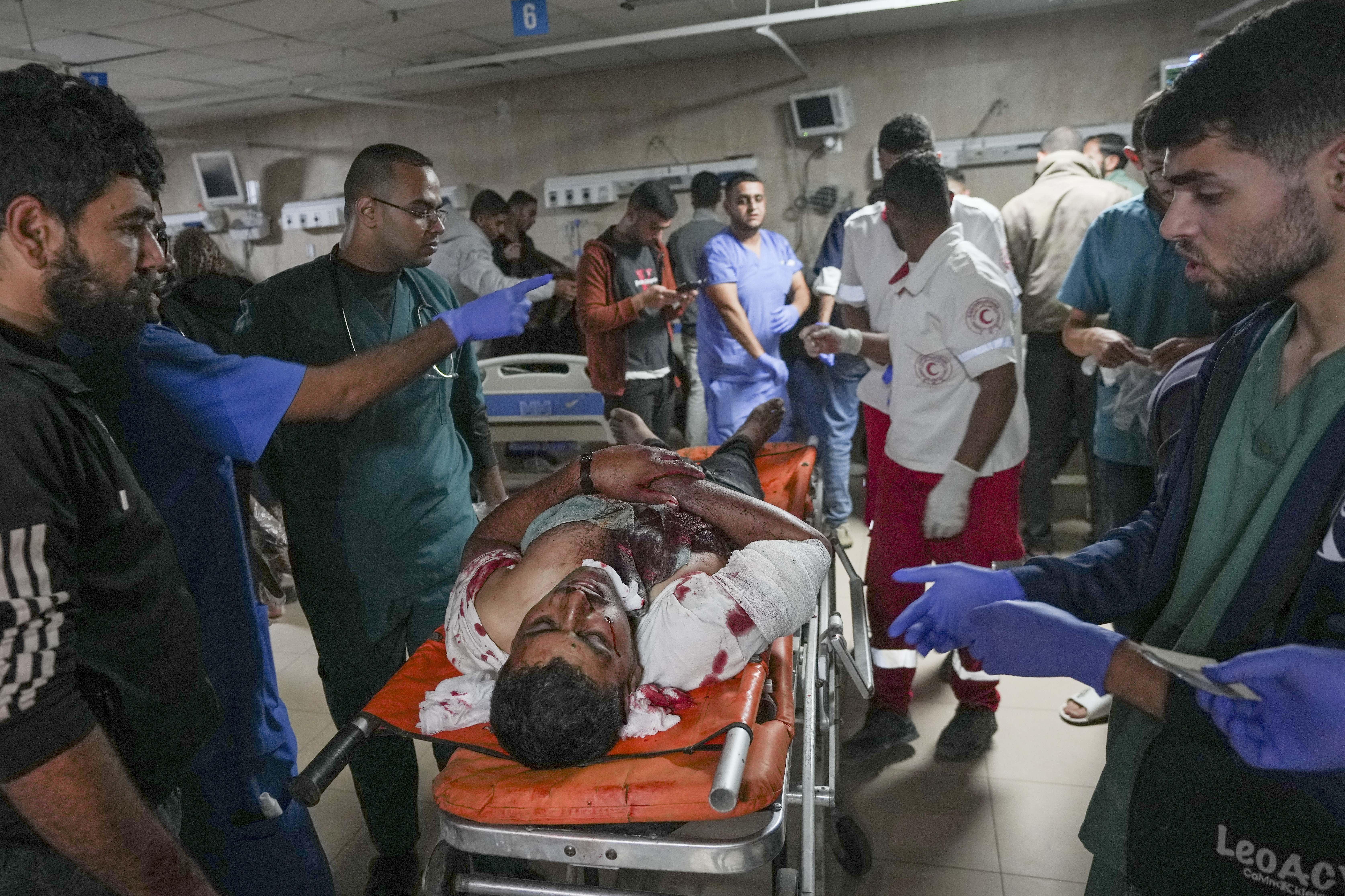 Medics carry a wounded man after an Israeli army strike at a hospital in Deir al-Balah, Gaza, late Saturday Nov. 16, 2024. Israeli strikes in the Gaza Strip overnight killed 12 people, Palestinian medical officials said Sunday. (AP Photo/Abdel Kareem Hana)