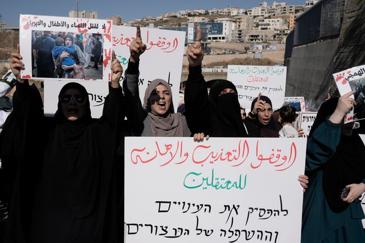 Palestinian women who are citizens of Israel march in support of those in Gaza and those detained in Israeli jails, in Umm Al-Fahm, Israel, Saturday, Aug. 3, 2024. The large sign in front reads, in Arabic: "Stop the torture and abuse of detainees."