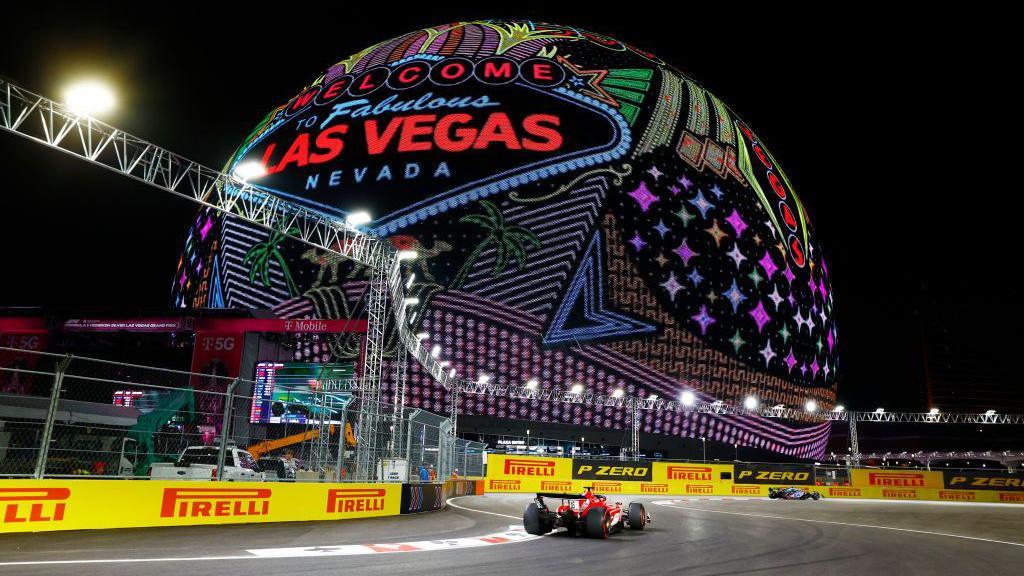 Charles Leclerc on track in Las Vegas with the Sphere in the background 