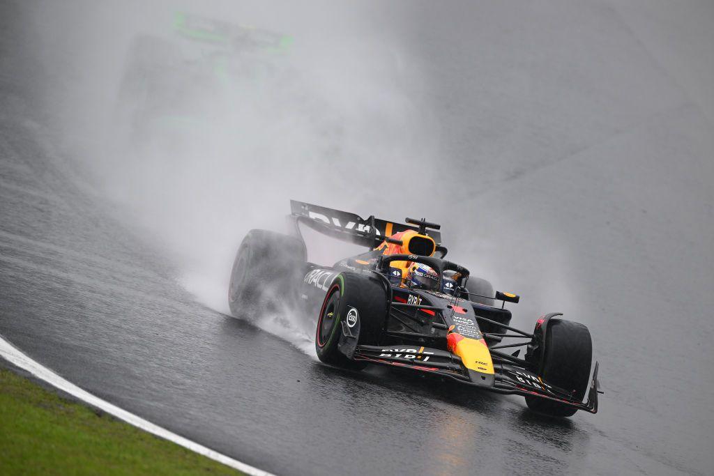 Max Verstappen's Red Bull throws up a cloud of spray as he enters the first corner at Interlogos during the 2024 Sao Paulo Grand Prix. A Sauber is just about visible behind him