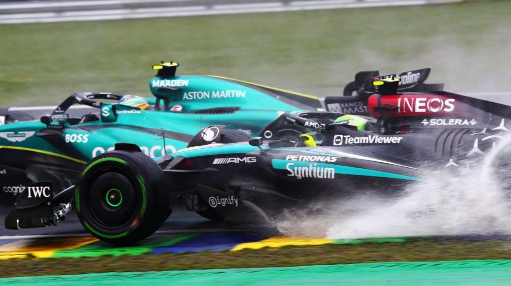 Spray comes up from Lewis Hamilton's Mercedes as he attempts to pass Aston Martin's Fernando Alonso during the 2024 Sao Paulo Grand Prix