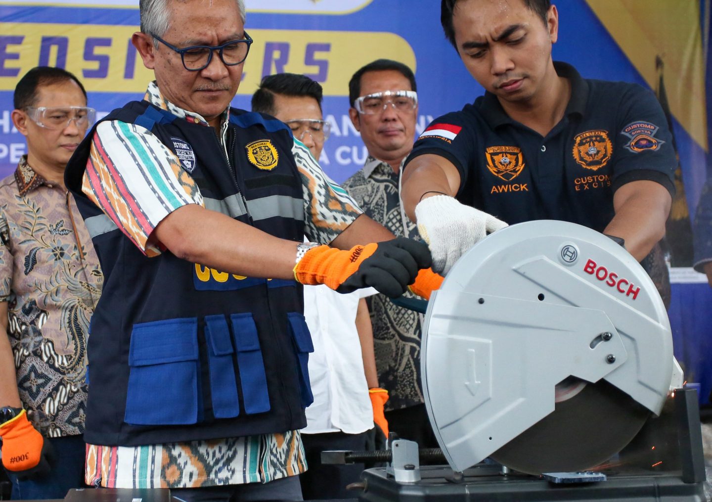 Indonesian customs officials destroy a smuggled iPhone 16 Pro Max that was confiscated alongside dozens of Apple phones and tablets, at the customs office of SoekarnoHatta International Airport in Tangerang, Banten, on Nov. 29, 2024. 