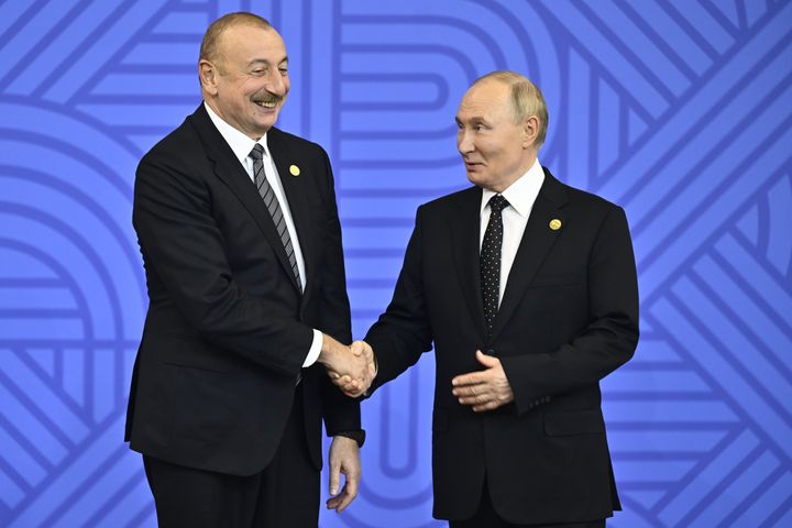 Russian President Vladimir Putin (R) welcomes President of Azerbaijan Ilham Aliyev during the start of the BRICS 2024 Summit in Kazan, Russia, on October 23.