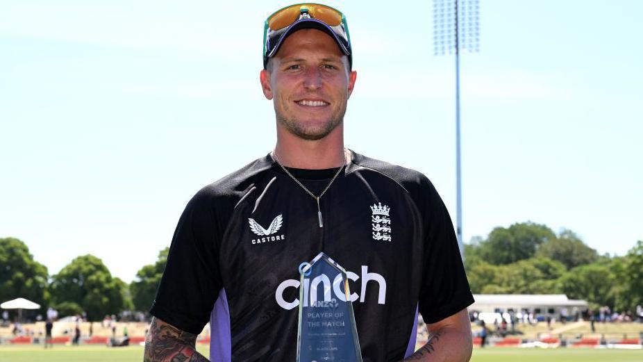 Brydon Carse with his player of the match trophy