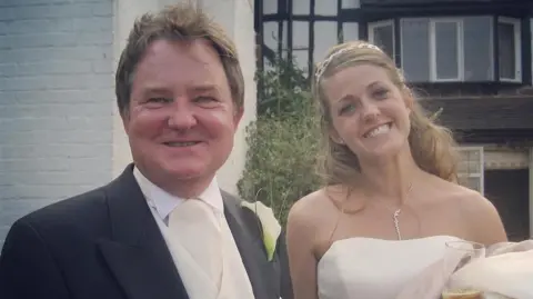 HANDOUT Amy, in her bridal gown, beams next to her father Steve, who wears a tuxedo 