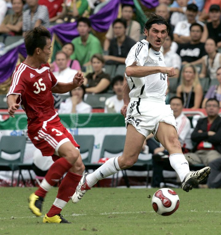 FIFA World Stars team's Mikheil Kavelashvili, right, makes a shot on the goal during the Reunification Cup against Chinese national team in Hong Kong, on July 1, 2007. (AP Photo/Brian Ching, File)