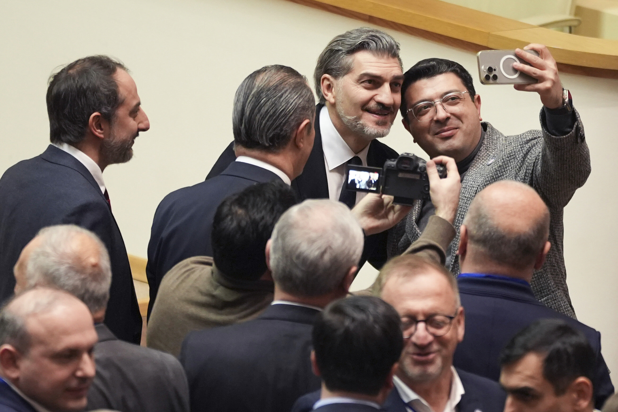 Georgian president-elect Mikheil Kavelashvili, 2nd right, poses for a selfie at the Georgian parliament, in Tbilisi, Georgia, Saturday. Dec. 14, 2024. (AP Photo)