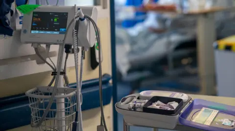 PA Media General view of medical equipment in front of a hospital bed on a NHS ward