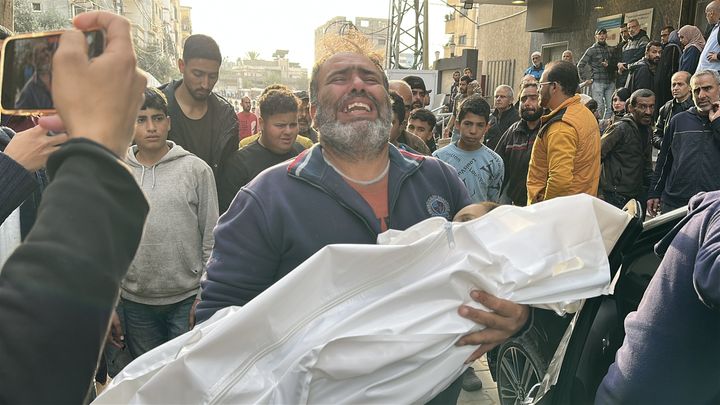 Palestinians mourn family members killed by Israel strikes on the Nuseirat refugee camp in central Gaza, on Dec. 11, 2024. The victims' corpses were brought to Al Awda Hospital ahead of the funeral and burial due to there also being a number of injured people.