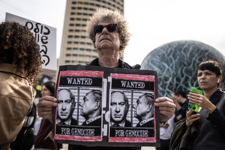 Demonstrators holding banners and placards gather outside the court for a protest as Israeli Prime Minister Benjamin Netanyahu arrives at the District Court in Tel Aviv to take the stand in his corruption trial for the first time in Tel Aviv, Israel on Dec. 10, 2024.