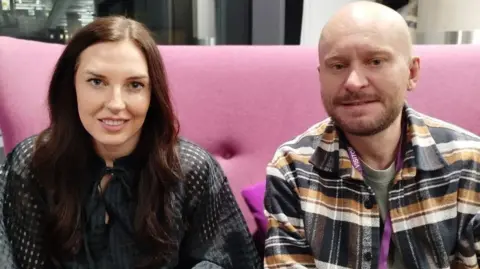 BBC Lauren Lane and Jamie Lonsdale in the green room at BBC Salford sitting on a pink sofa