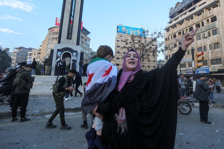 Syrians gather around the Clock Tower during celebrations in the heart of Homs early on December 8, 2024, after rebel forces entered Syria's third city overnight. Hayat Tahrir al-Sham (HTS) and allied anti-goovernment factions have pressed a lightning offensive since November 27, sweeping swathes of the country from government control, including major cities Aleppo, Hama and Homs. (Photo by Bakr ALKASEM / AFP) (Photo by BAKR ALKASEM/AFP via Getty Images)