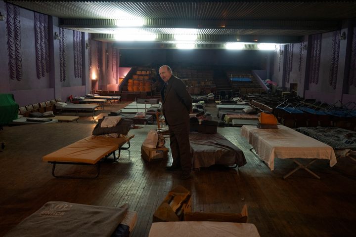 A man waits for evacuation to western Ukraine as he stands by a bed in a city theatre that hosts refugees running from Russian offensive in the Donetsk region, in Pavlohrad, Dnipropetrovsk region, Ukraine, on Dec. 12, 2024.