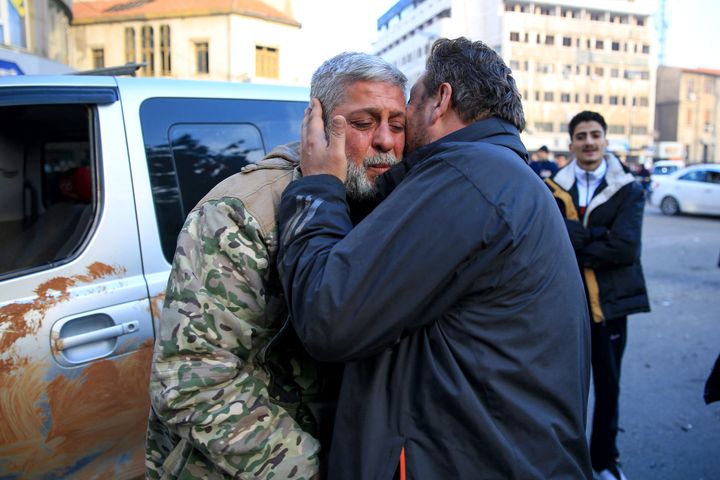 A man kisses a Syrian rebel fighter who returned to the central city of Homs on December 8, 2024, after being in exile for 12 years after rebel forces entered Syria's third city overnight. (Photo by Aref TAMMAWI / AFP) (Photo by AREF TAMMAWI/AFP via Getty Images)