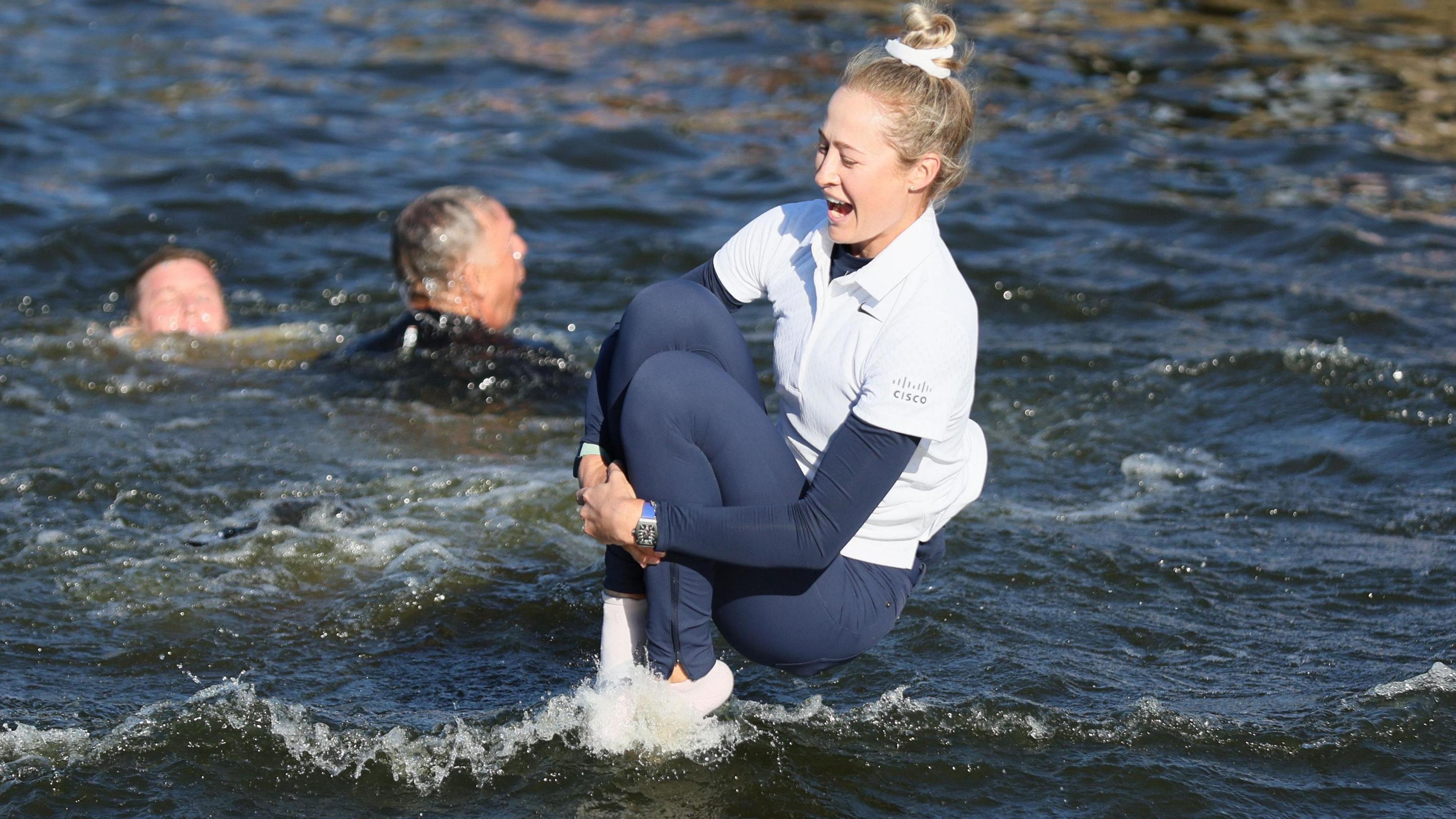 Nelly Korda jumping in a pond after winning the Chevron Championship