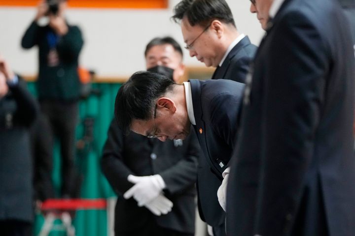 South Korea's acting President Choi Sang-mok bows for the victims on a plane which skidded off a runway and burst into flames, at a memorial altar at Muan sport park in Muan, South Korea, on Dec. 30, 2024. 