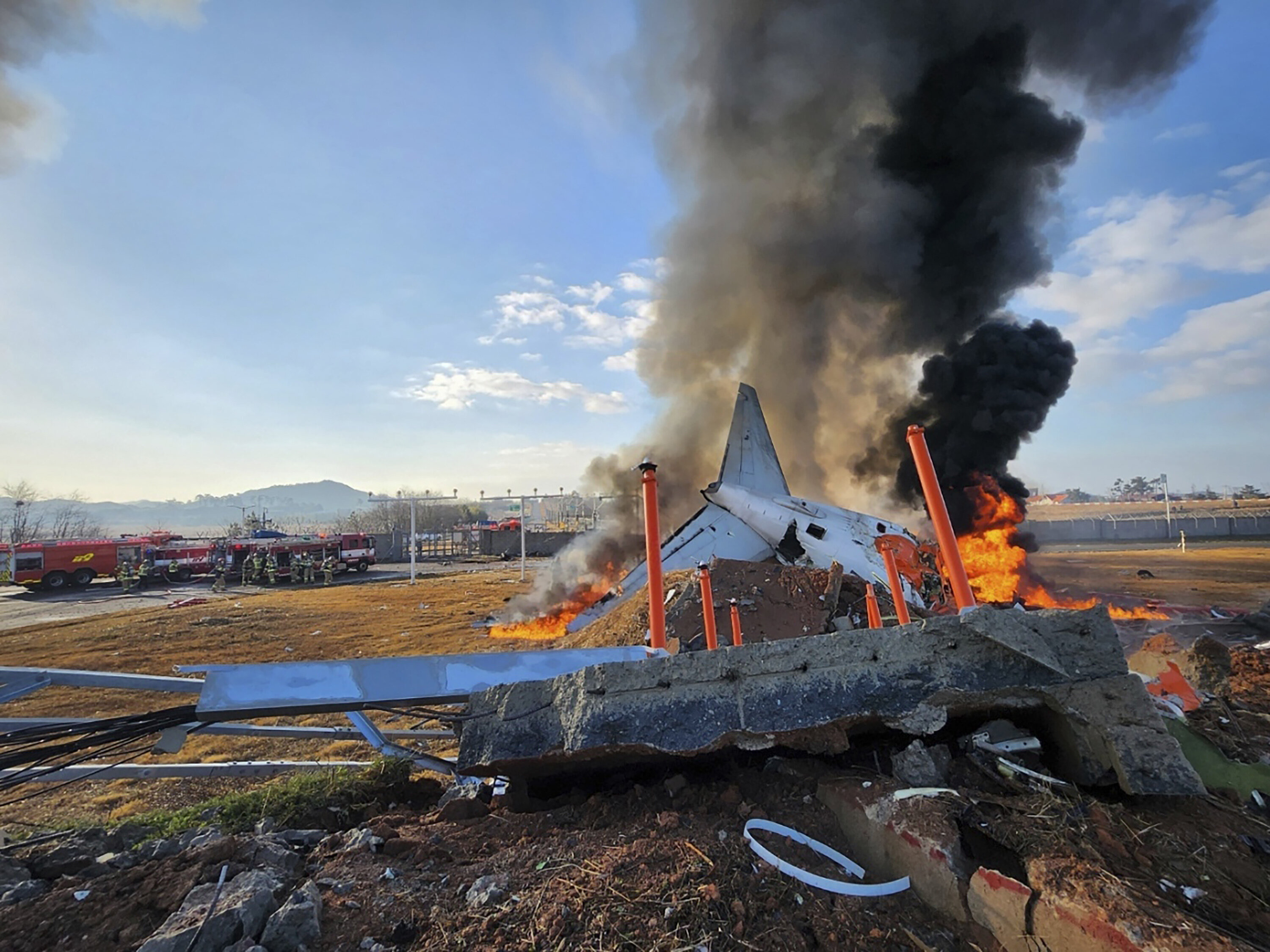 In this photo provided by South Korea's Muan Fire Station, a passenger plane is in flames at the Muan International Airport in Muan, South Korea, on Dec. 29, 2024.