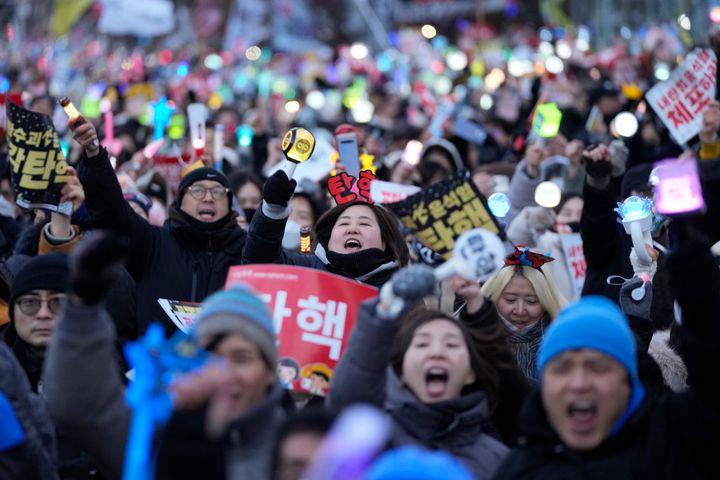 Participants celebrate after hearing the news that South Korea's parliament voted to impeach President Yoon Suk Yeol outside the National Assembly in Seoul, South Korea, Saturday, Dec. 14, 2024. (AP Photo/Ahn Young-joon)