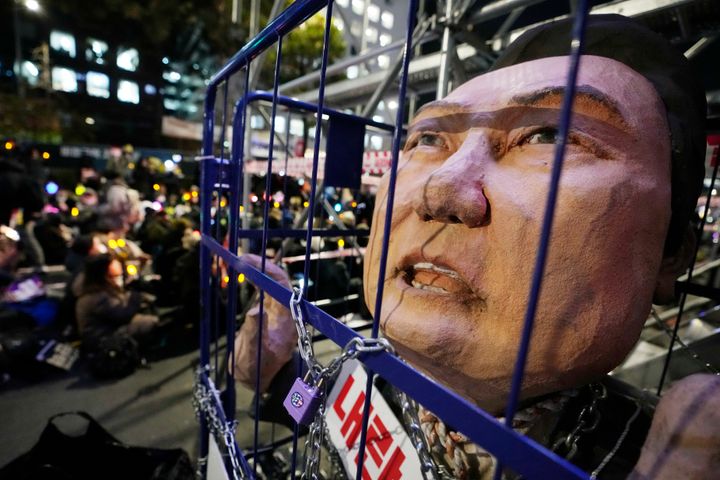 A caricature depicting an imprisoned South Korean President Yoon Suk Yeol is displayed during a rally to demand his impeachment outside the National Assembly in Seoul, South Korea, Friday, Dec. 13, 2024. (AP Photo/Ahnn Young-joon)