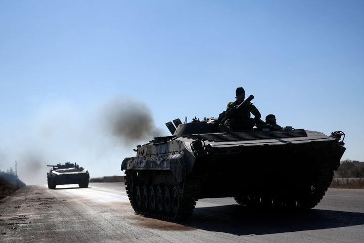 Syrian opposition fighters drive a seized seized Syrian army armoured vehicle near the town of Khan Assubul, Syria, southwest of Aleppo, on Dec. 1, 2024.