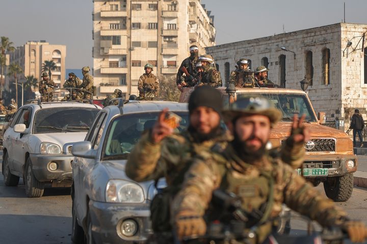 Syrian opposition fighters ride along the streets in the aftermath of the opposition's takeover of Hama, Syria, Friday, Dec. 6, 2024. (AP Photo/Ghaith Alsayed)