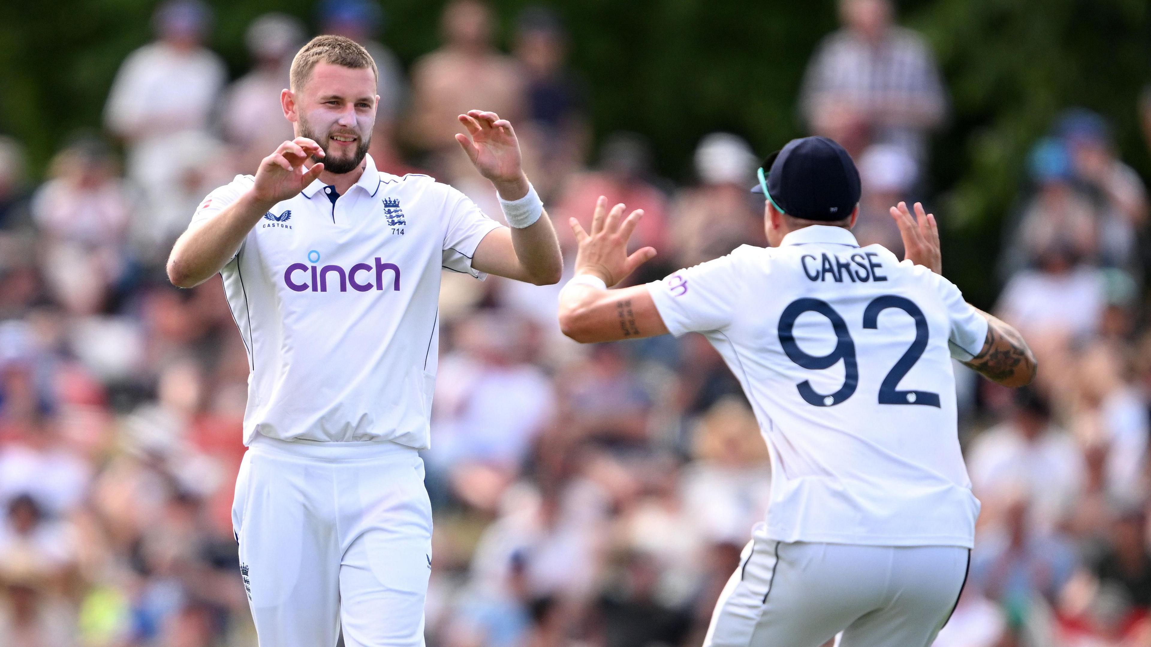 England bowlers Gus Atkinson (left) and Brydon Carse (right) celebrate a wicket