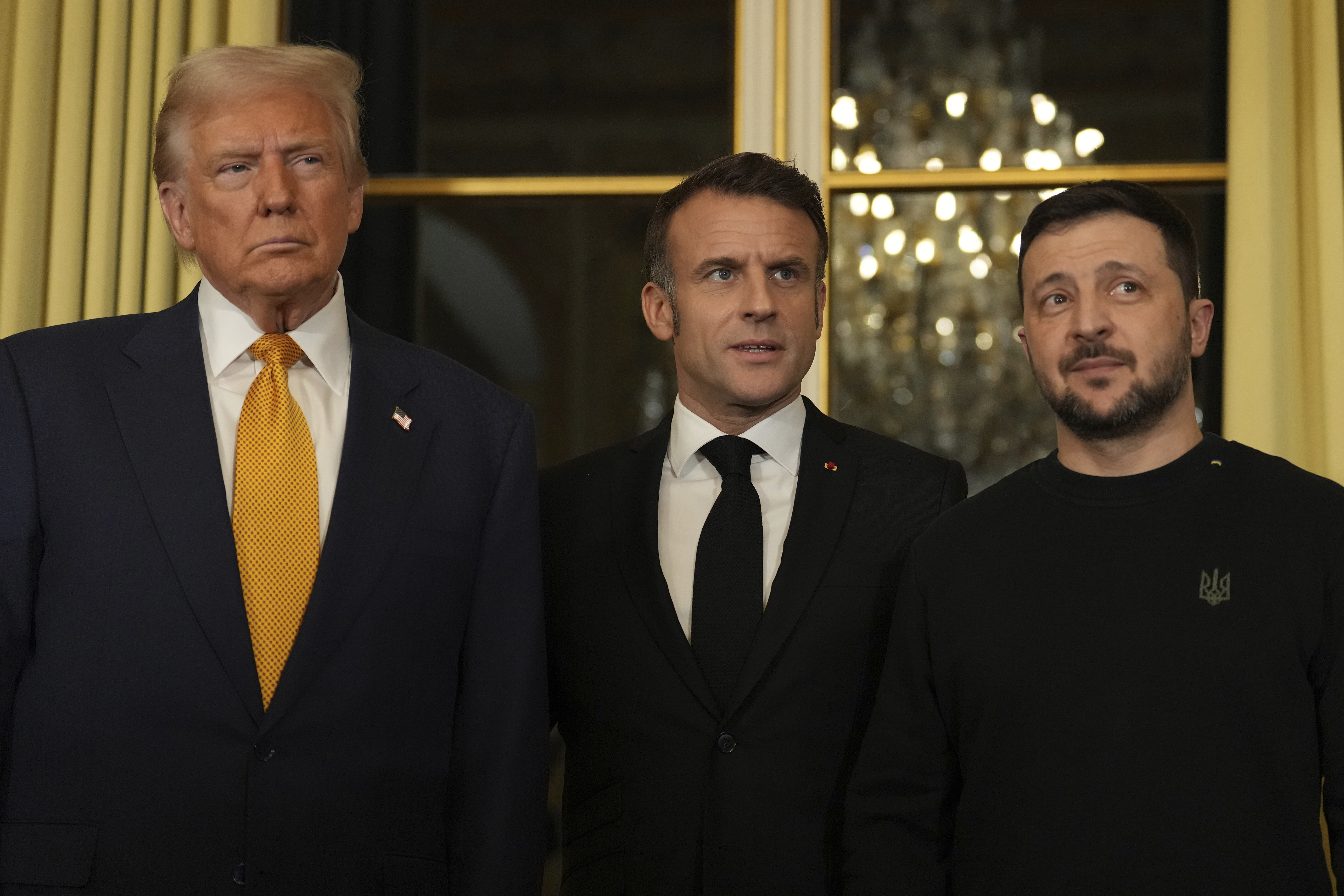 French President Emmanuel Macron, center, poses with President-elect Donald Trump, left, and Ukraine's President Volodymyr Zelenskyy at the Elysee Palace, Saturday, Dec. 7, 2024 in Paris.