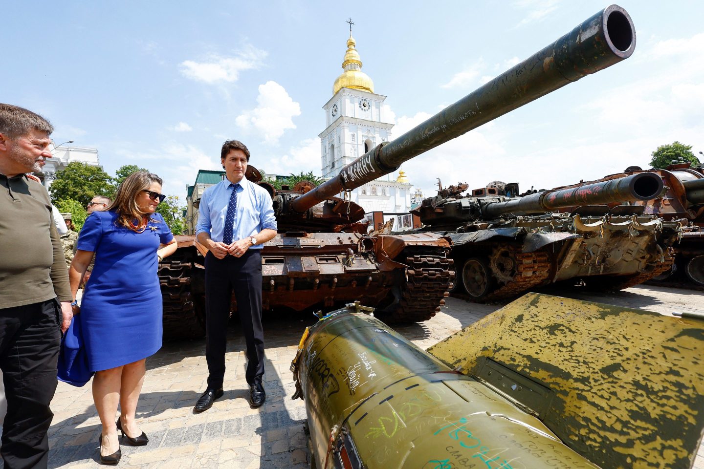 Canadian Prime Minister accompanied by Canada's Minister of Finance Chrystia Freeland, (2nd L) visit an exhibition of destroyed vehicles on the day of his visit to the Wall of Remembrance to pay tribute to Ukrainian soldiers killed amid Russia's attack on Ukraine on June 10, 2023 in Kyiv.