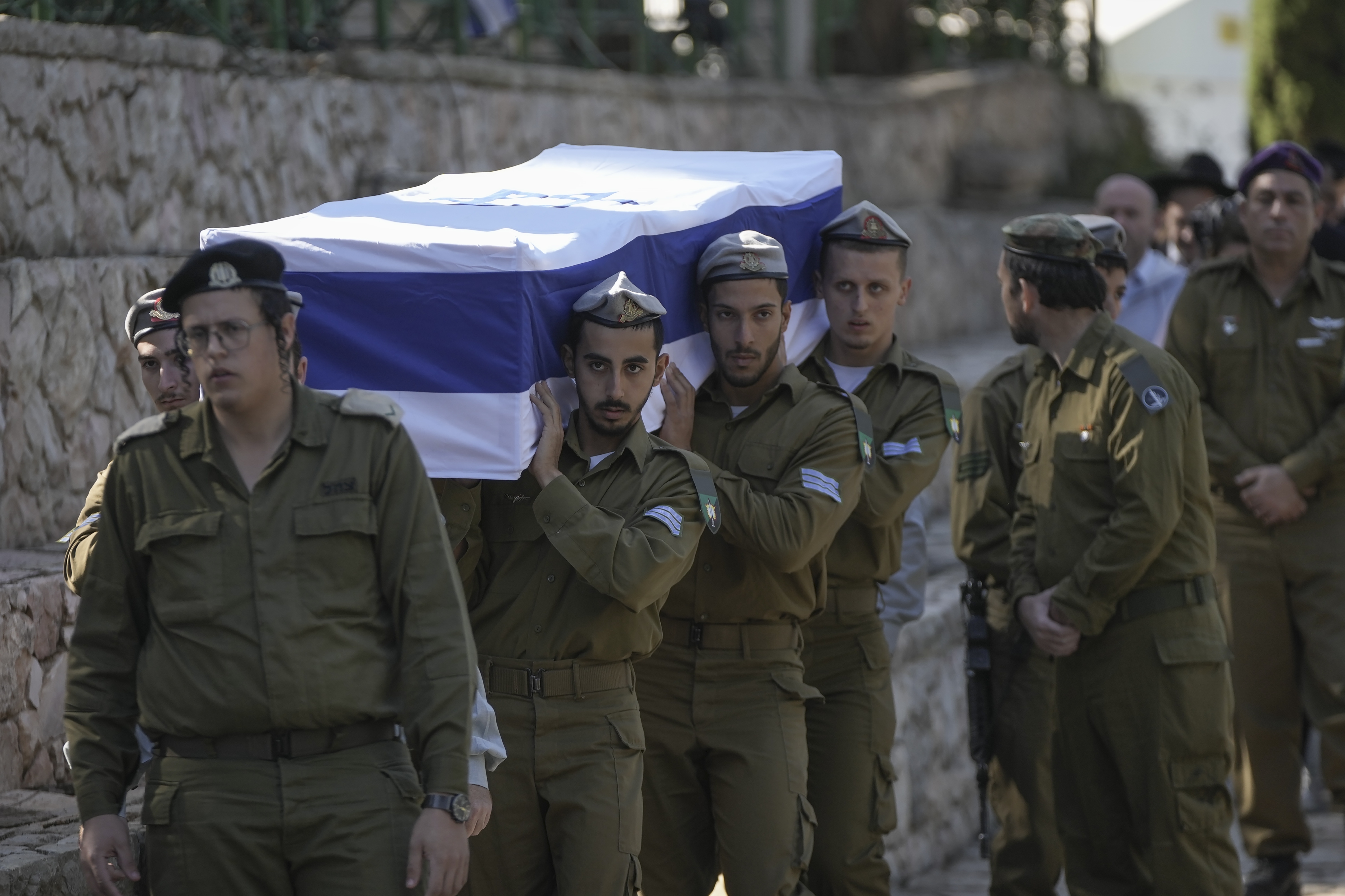 Israeli soldiers carry the coffin of combat engineer squad commander Staff Sgt. Zamir Burke, 20, from Beit Shemesh, during his funeral at Mount Herzl military cemetery in Jerusalem, Israel, Sunday Nov. 1, 2024. Burke was killed in combat with Hamas at the Jabaliya refugee camp in Gaza. (APcPhoto/Mahmoud Illean)