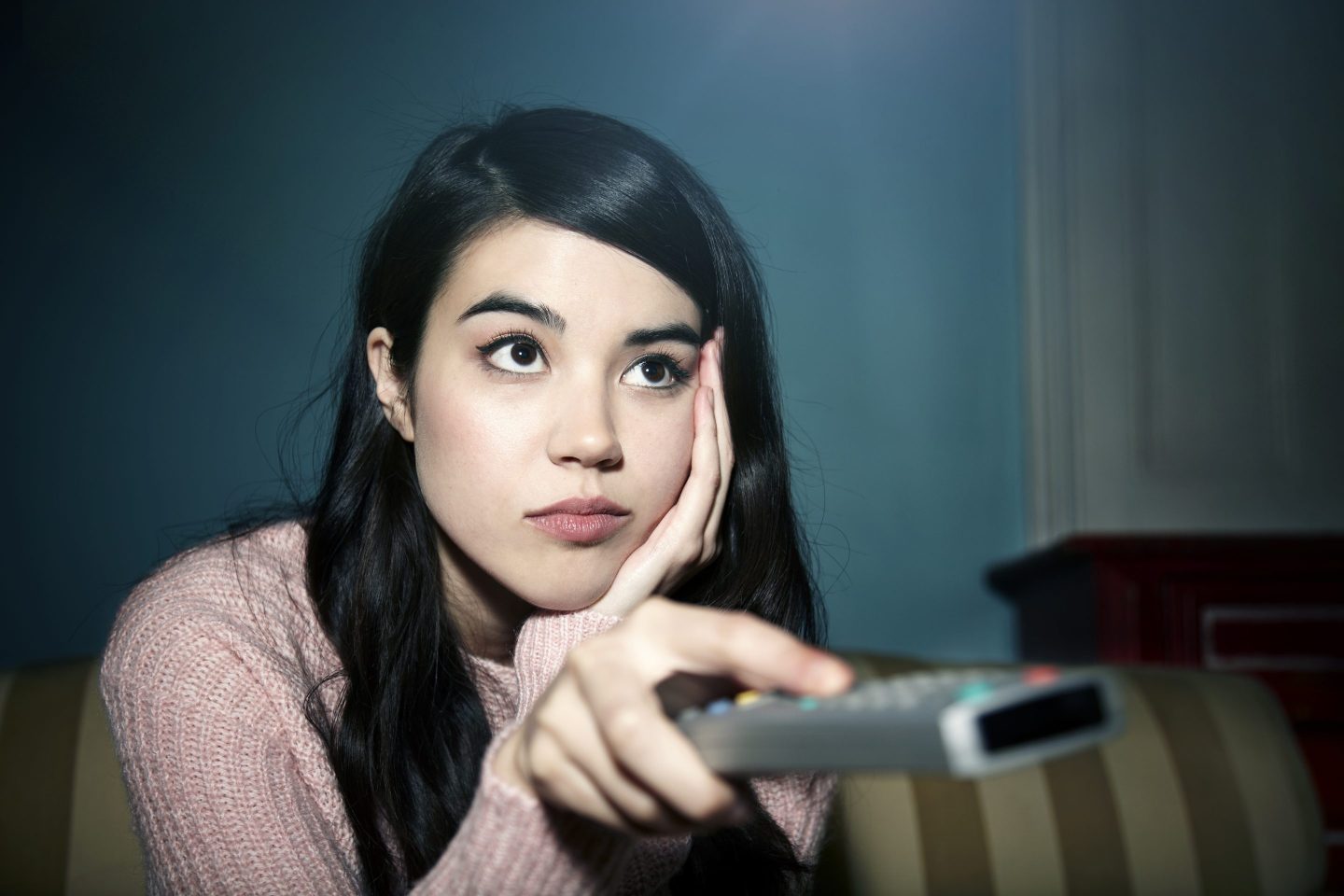 Bored woman watching TV