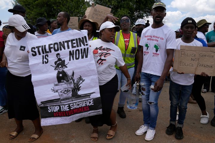 Families of miners and activist protest as South Africa's police minister visited the mine on Tuesday.