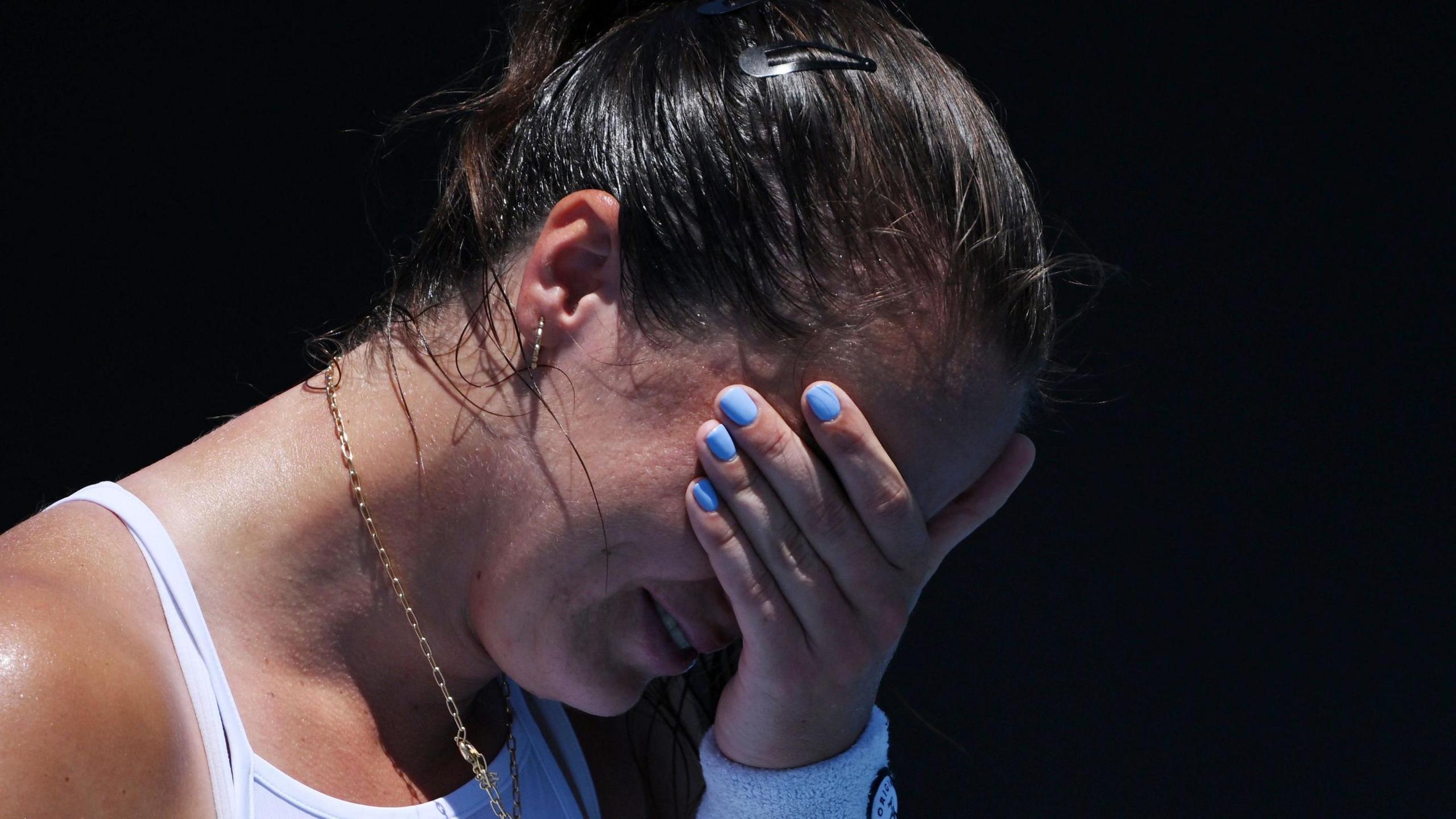 An emotional Jodie Burrage covers her face after beating Leolia Jeanjean in the Australian Open first round