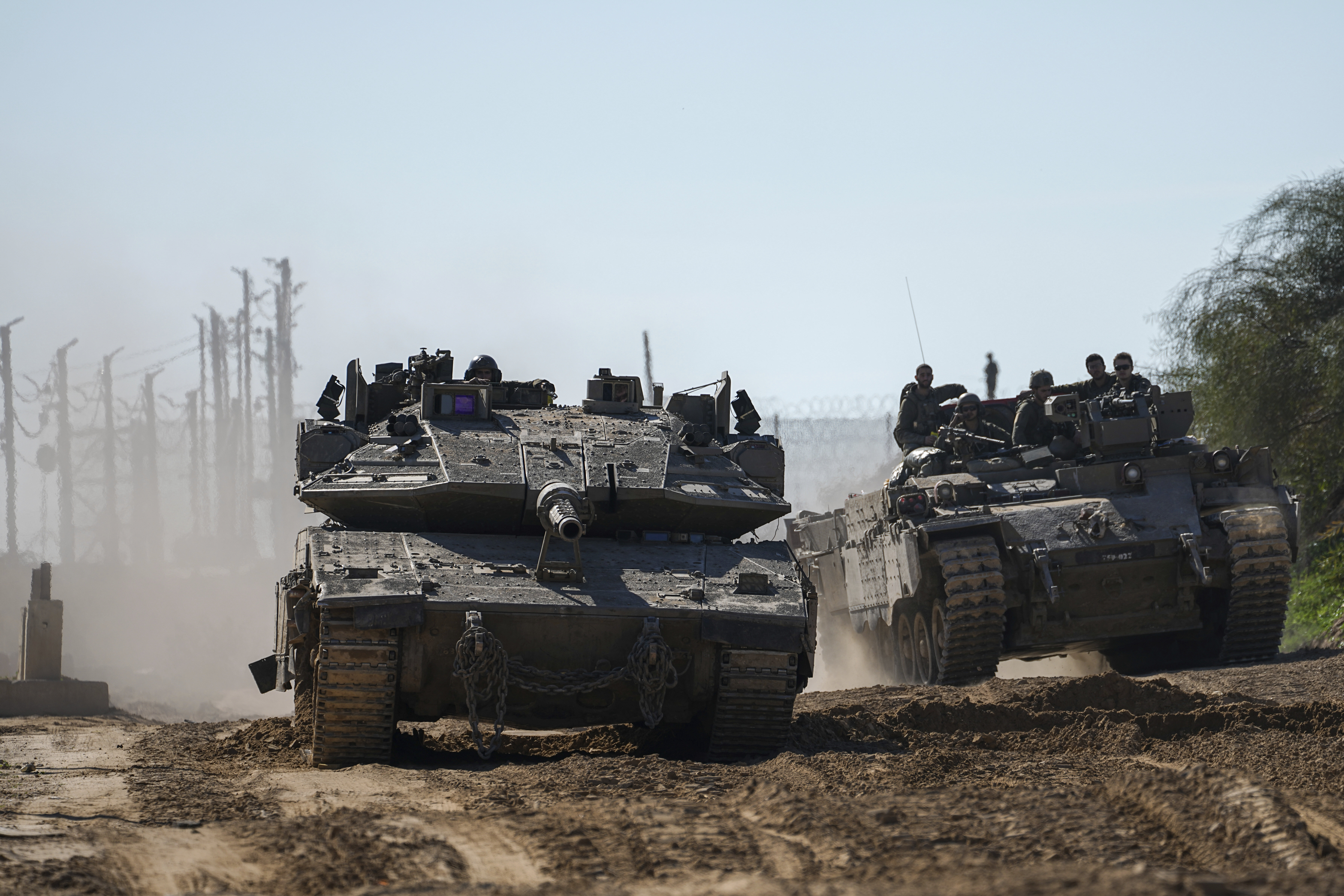 Israeli troops are crossing into Israel from the Gaza Strip, Saturday, Jan. 18, 2025. (AP Photo/Tsafrir Abayov)