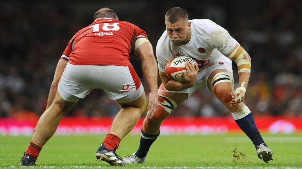 Tom Willis takes on a Welsh tackler