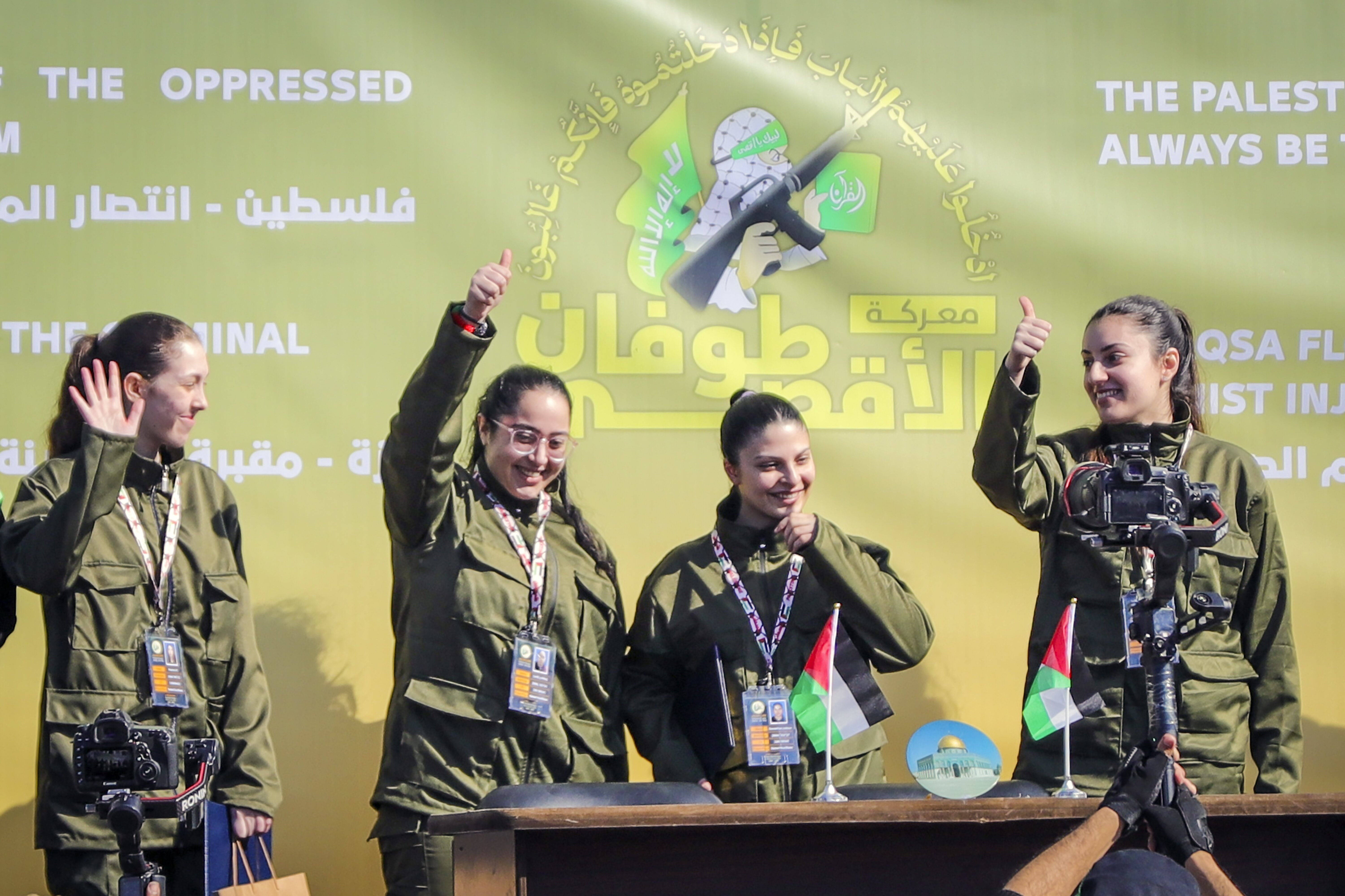 Israeli soldier hostages Naama Levy, Daniella Gilboa, Karina Ariev and Liri Albag, in no particular order, salute a Palestinian crowd before being handed over to the Red Cross in Gaza City, Saturday, Jan. 25, 2025. (AP Photo/Abed Hajjar)