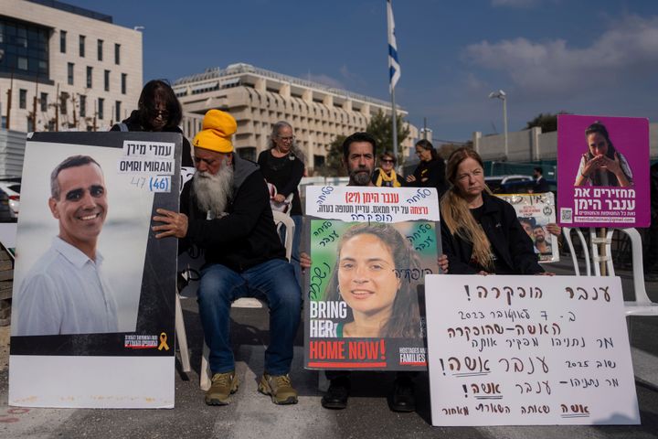 Families and supporters of Israeli hostages held in Gaza by Hamas, hold photos of their loved ones during a protest for their release outside the prime minister's office in Jerusalem, on Sunday, Jan. 26, 2025.