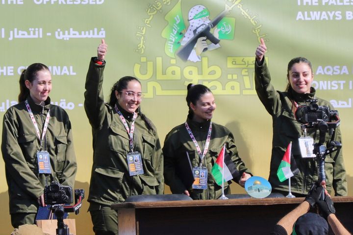 Israeli female soldier who were just released from Hamas captivity wave and react at a Palestinian crowd before being handed over to the Red Cross in Gaza City, on Saturday, Jan. 25, 2025.