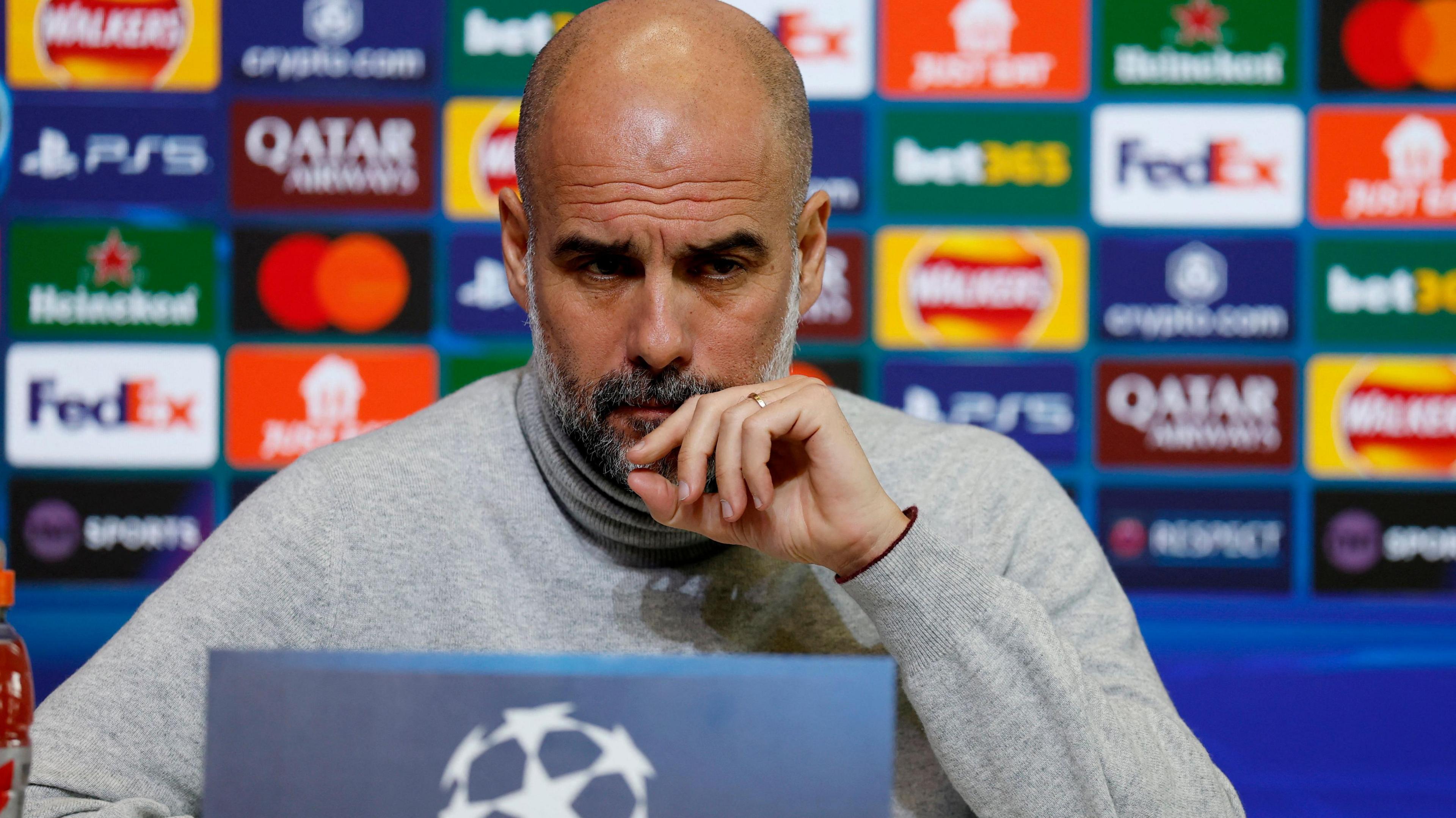 Pep Guardiola listens to a question during his Champions League news conference